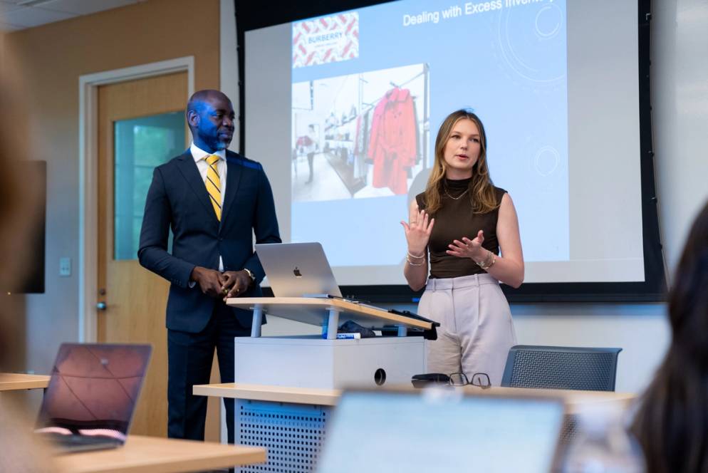 A Rollins student does a presentation in Supply Chain Management alongside an international business professor.