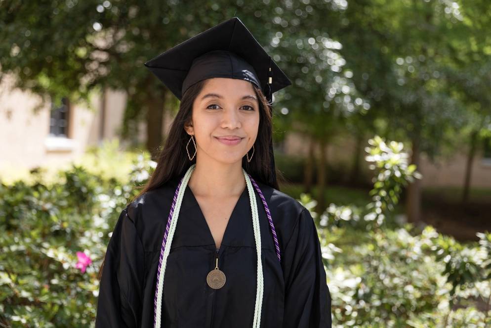 A valedictorian poses on the Rollins College campus.