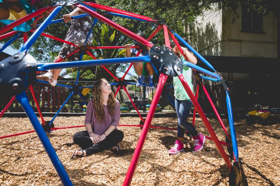 Education major Abigail Goecker Bokorney ’16 on the playground with students she worked with as a Bonner Leader at Rollins