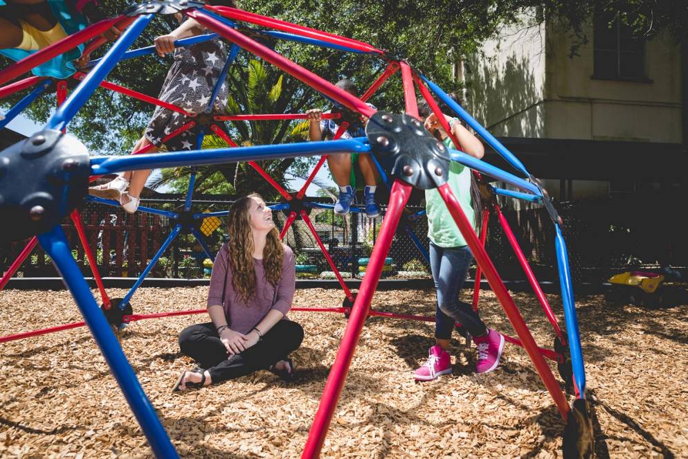 Education major Abigail Goecker Bokorney ’16 on the playground with students she worked with as a Bonner Leader at Rollins