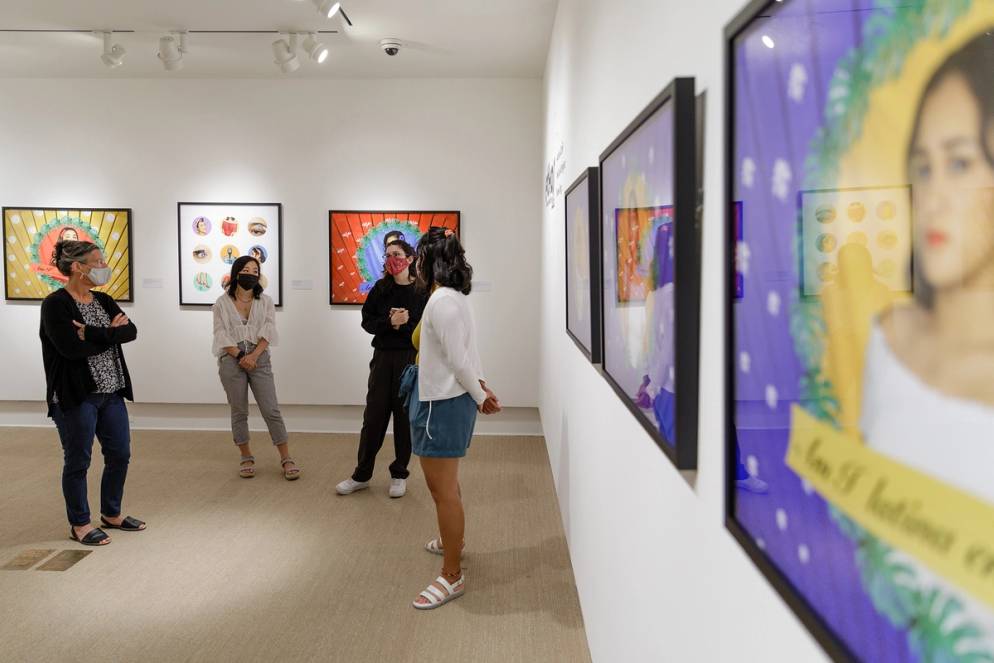 Art professor Dawn Roe and studio art seniors discussing their original art exhibition at the Cornell Fine Arts Museum.