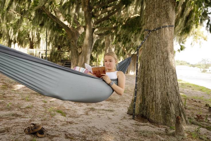 Student studying in a hammock in Dinky Dock Park, just steps from campus.