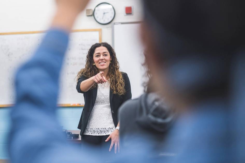 A music teacher leads a class of middle school students.