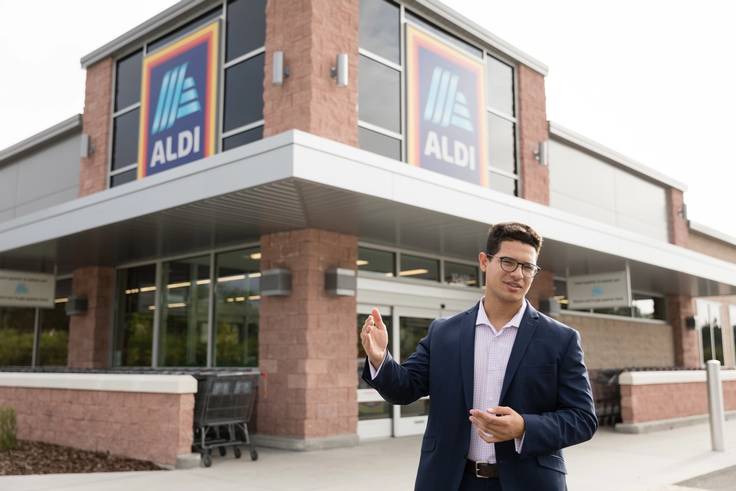 Management intern poses outside an ALDI store in Florida.