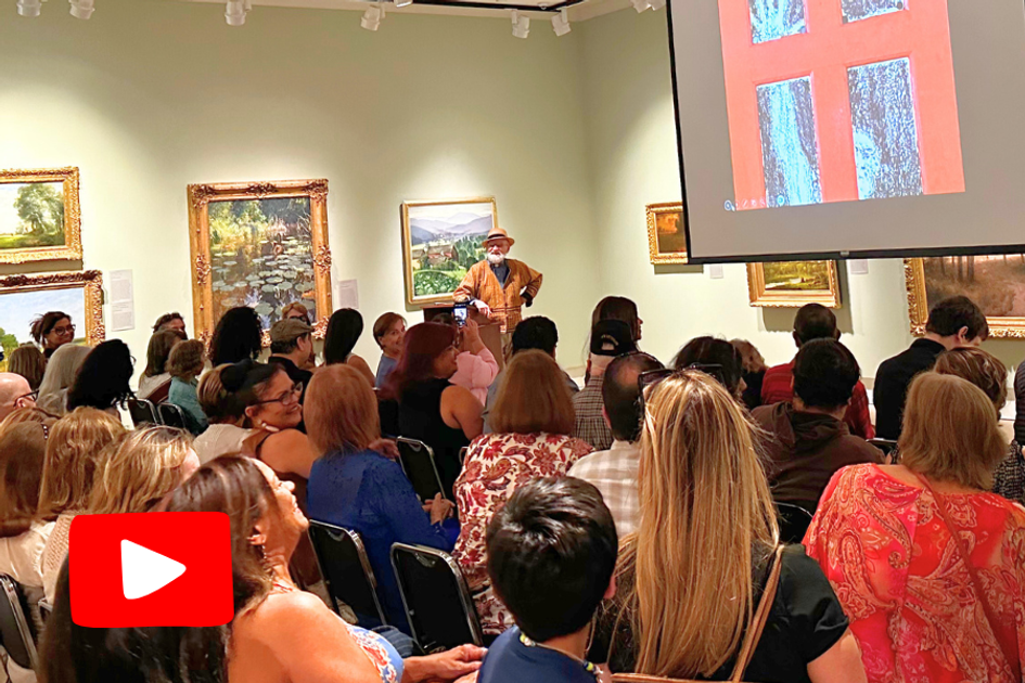 Man stands before a crowd in an art gallery