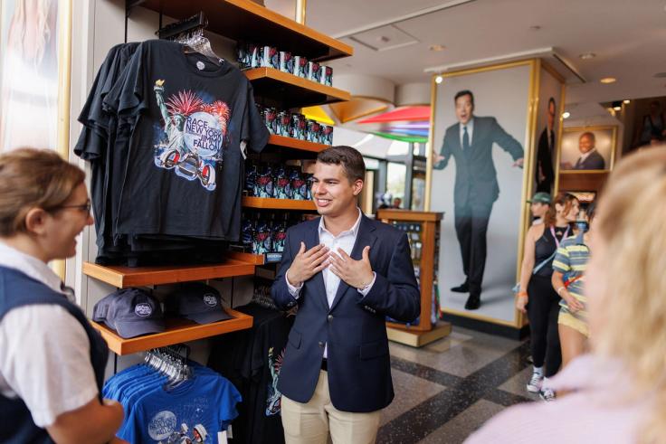 Michael Lagessie ’24 speaking to a Universal merchandising team member