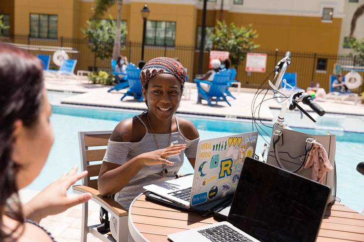 Students studying by the pool at Lakeside Neighbhorhood.