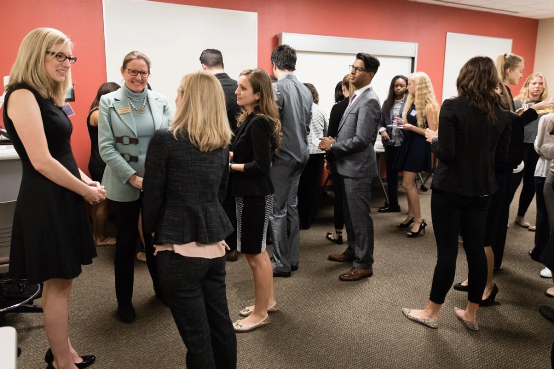 A group of sharp dressed business students networking.