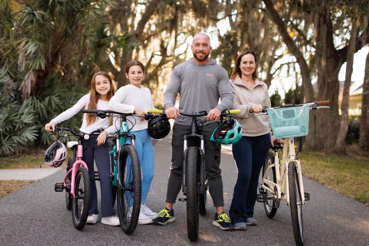 Eric Reichwein poses with his wife and daughters after a family bike ride.