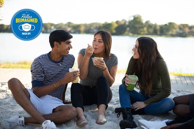 Students enjoy snacks in between studying on the beach near Lake Virginia.