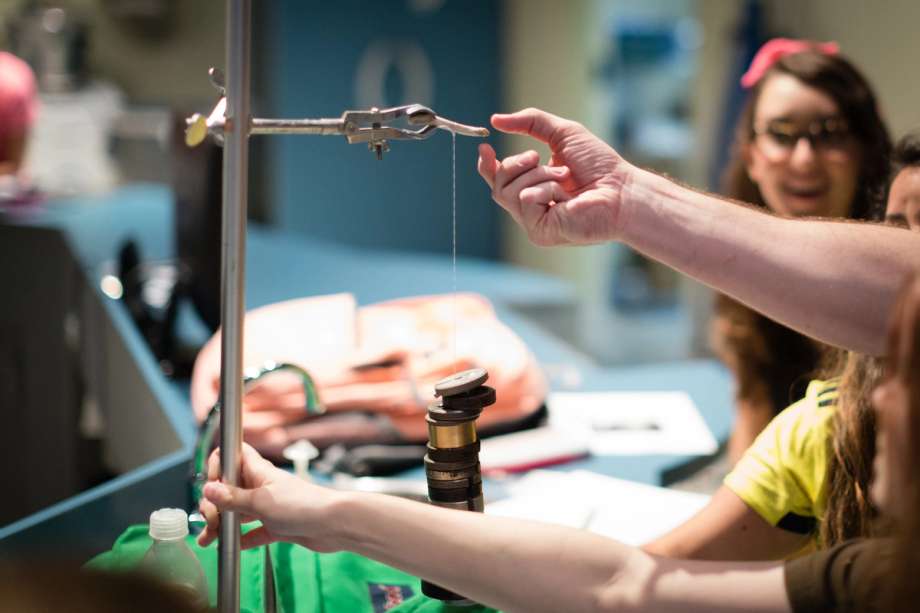 Students experimenting with weights and measures in a physics class.