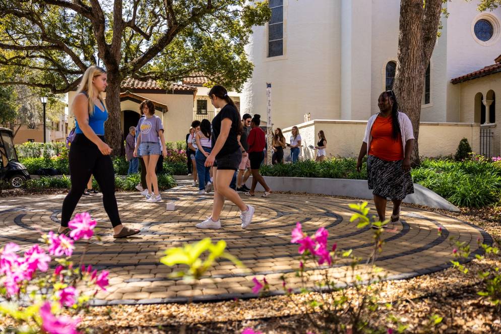 Students, staff, and faculty walking through the labyrinth