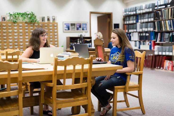 Rollins professor and student conducting research on women’s studies.