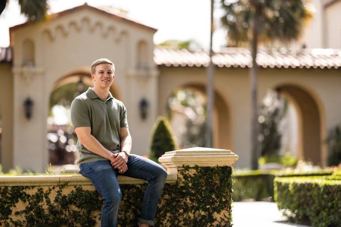 Connor Celentano in the rose garden at Rollins College