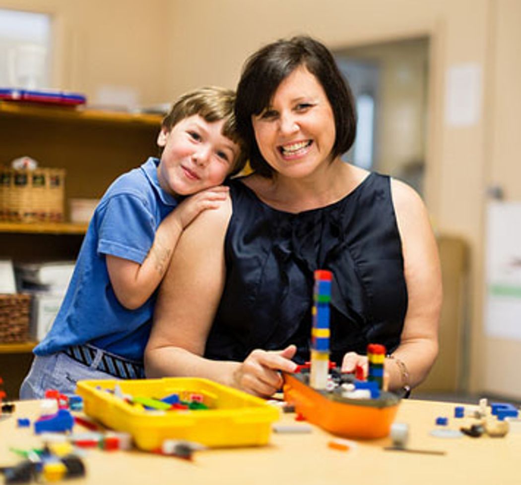 A child and parent smile together in the CDC.