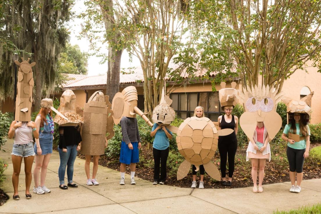 Students pose outside with their sculptures.