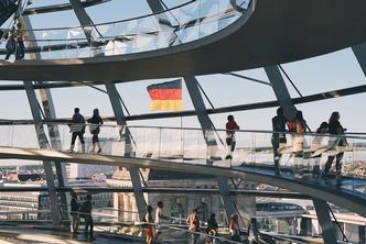 People walk around a modern building in Germany.