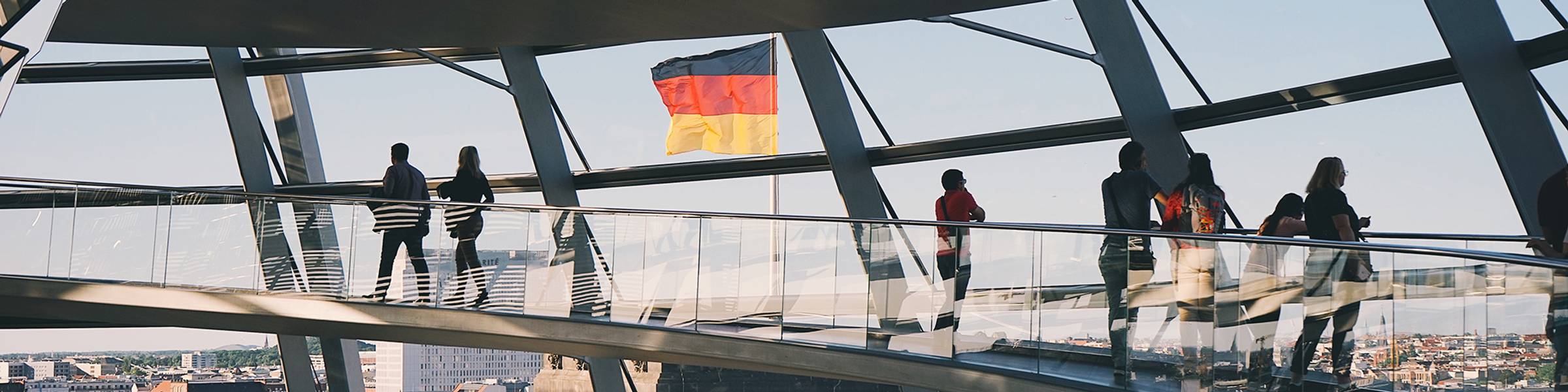People walk around a modern building in Germany.