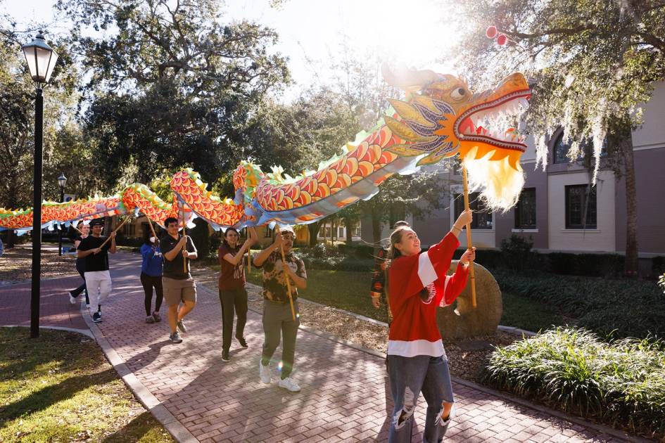 students holding dragon kite