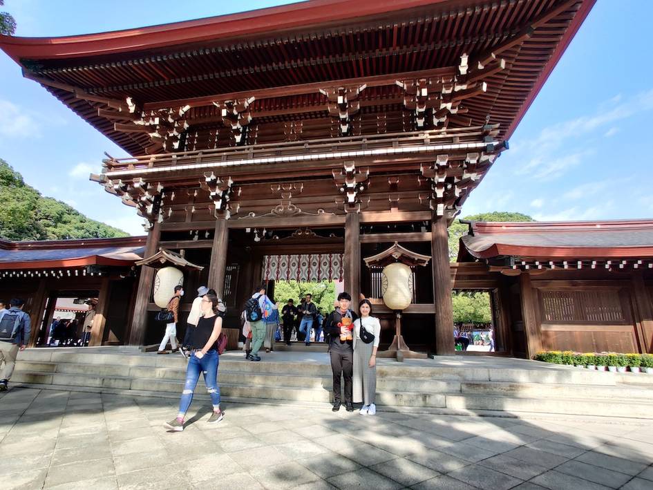 Students posing in front of a historical structure in Japan.