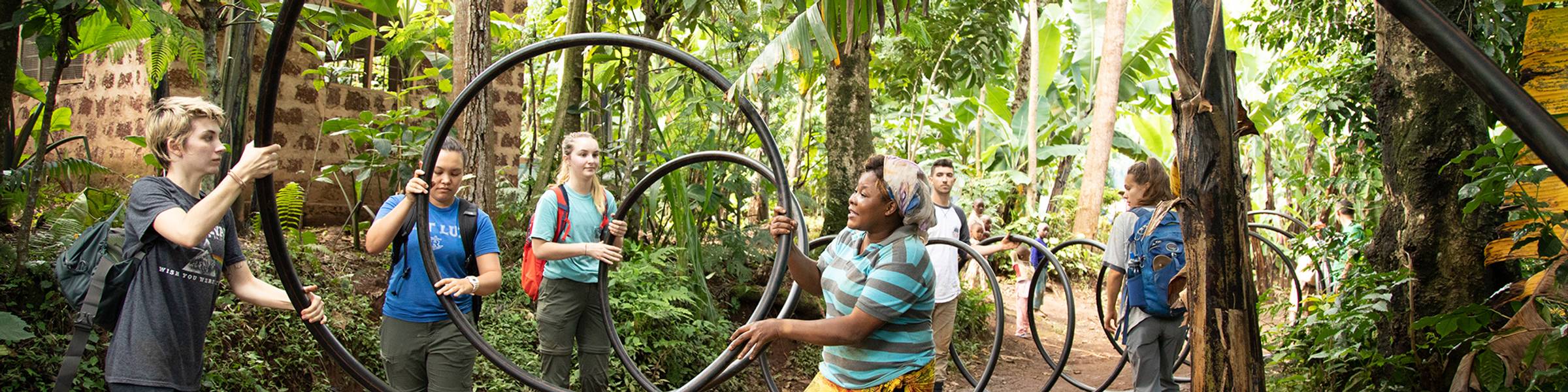 Students help install irrigation infrastructure in a village in Tanzania.