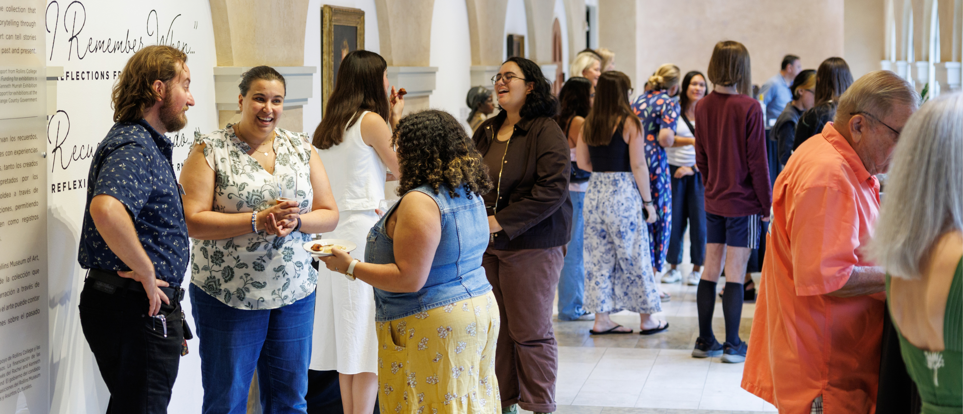 Guests mingle and converse during a lively indoor reception.