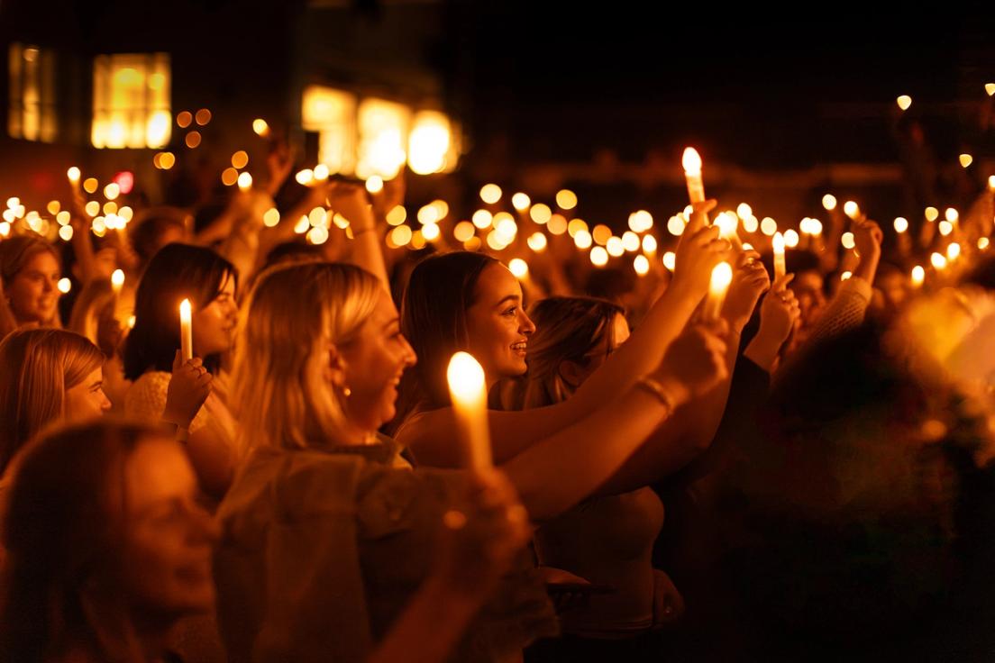 Students hold candles during Candlewish ceremony at orientation.