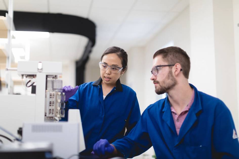 A chemistry professor and a student conduct collaborative research in a lab.