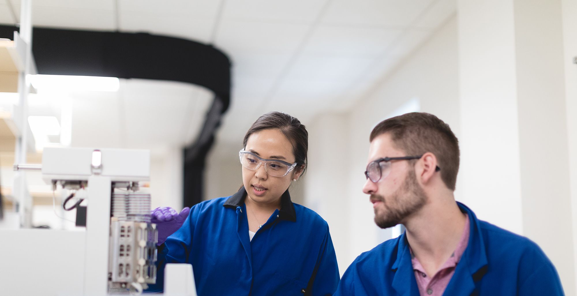 Chemistry students handling chemicals in a lab.
