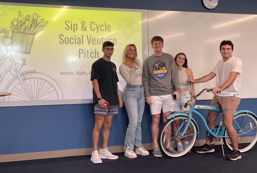 Group of social entrepreneurship students in a classroom pitching a social venture