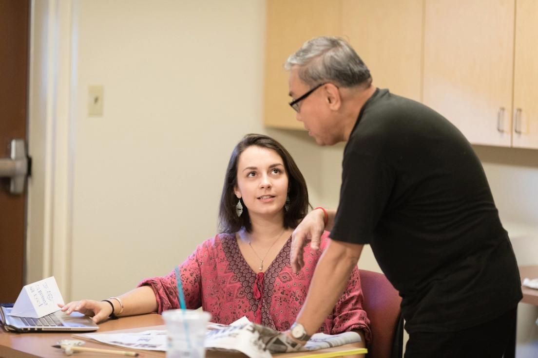 A professor works with a student in a Chinese calligraphy course.