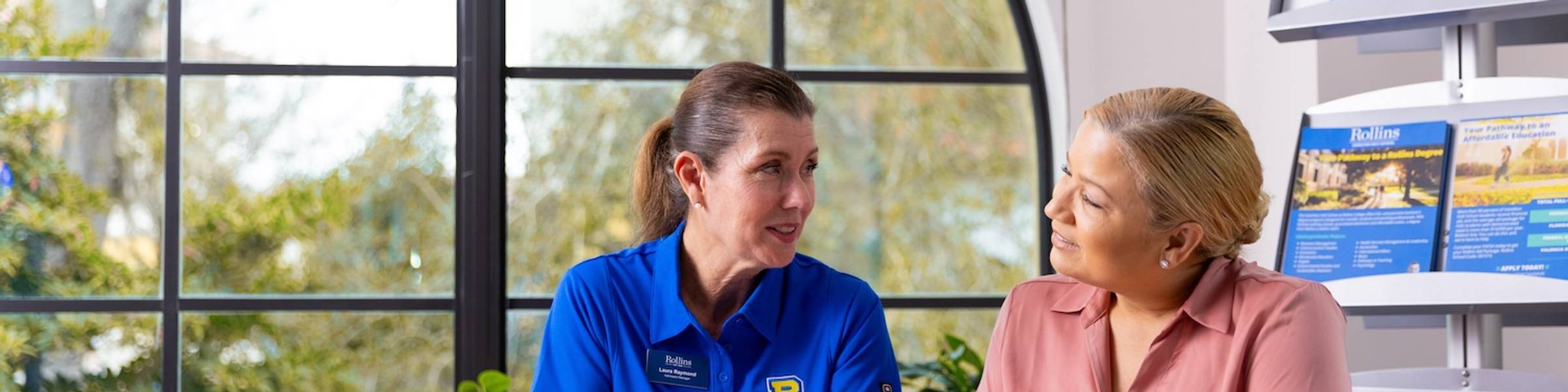 An admission counselor walks a prospective student through the admission process.