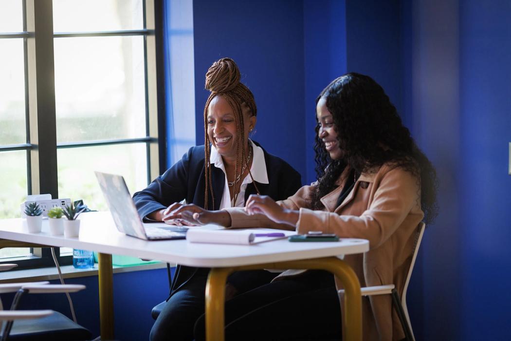 An alumni mentor works one on one with a student.