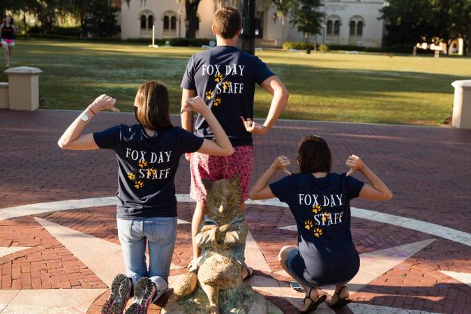 Fox Day staff pose with their T-shirts with the fox on Tars Plaza.