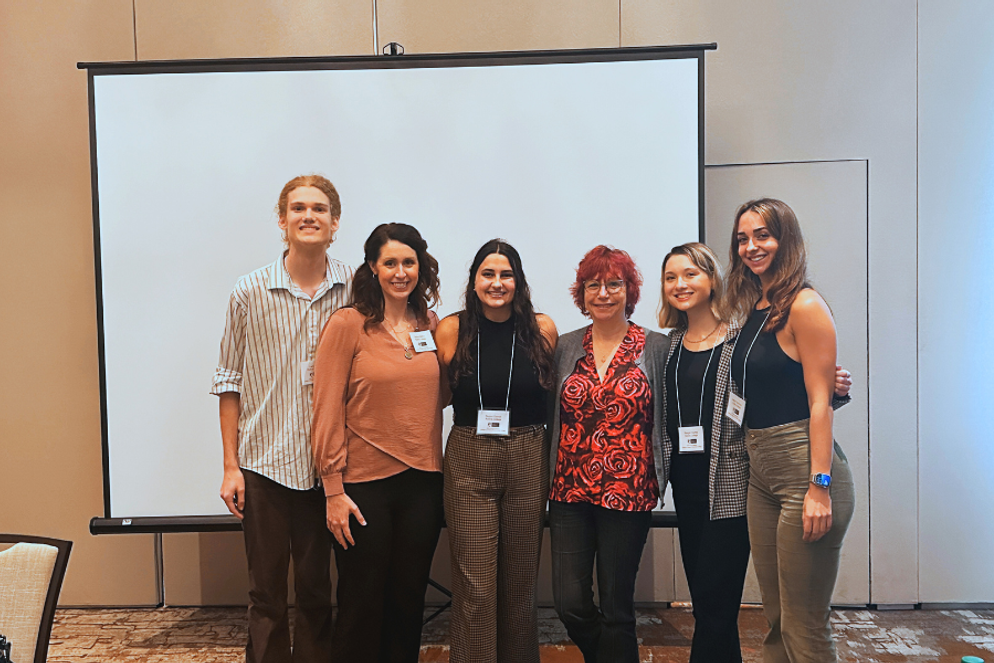 Reagan Cooney with her research mates and Rollins professors at the conference