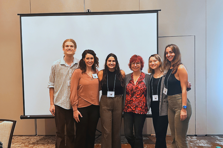 Reagan Cooney with her research mates and Rollins professors at the conference