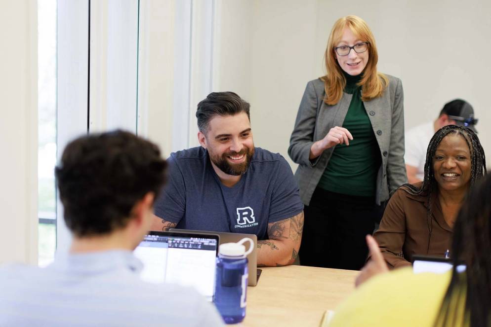 Students discuss topics in class with professor Ann Stone