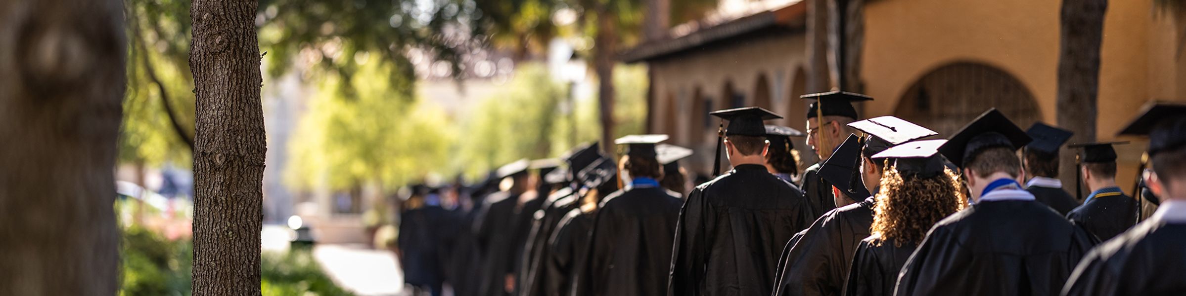 Students walking toward commencement ceremony