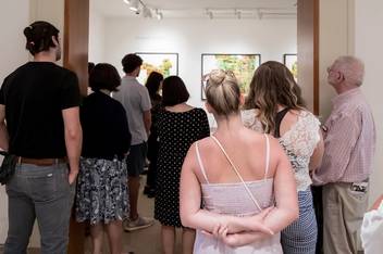 Onlookers at the senior art show in Rollins’ Cornell Fine Arts Museum.