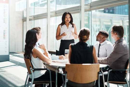 A communications professional leads a small group meeting.