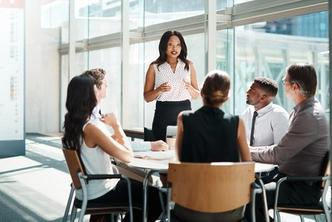 A communications professional leads a small group meeting.