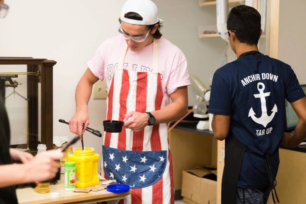 A student measures out cornstarch during a chemistry experiment.