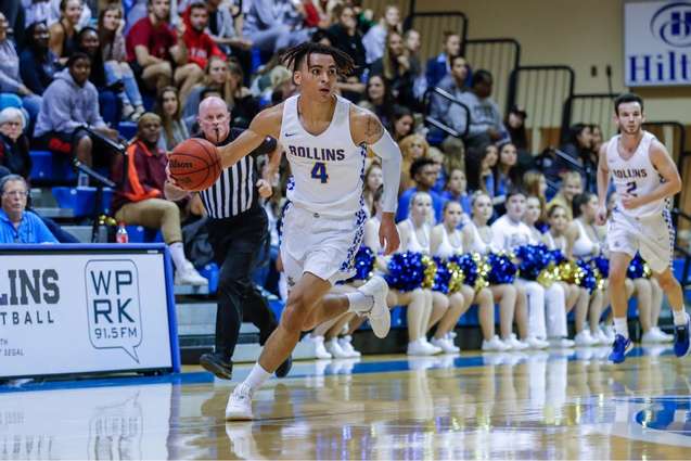 An athlete dribbling down the court during the basketball game.