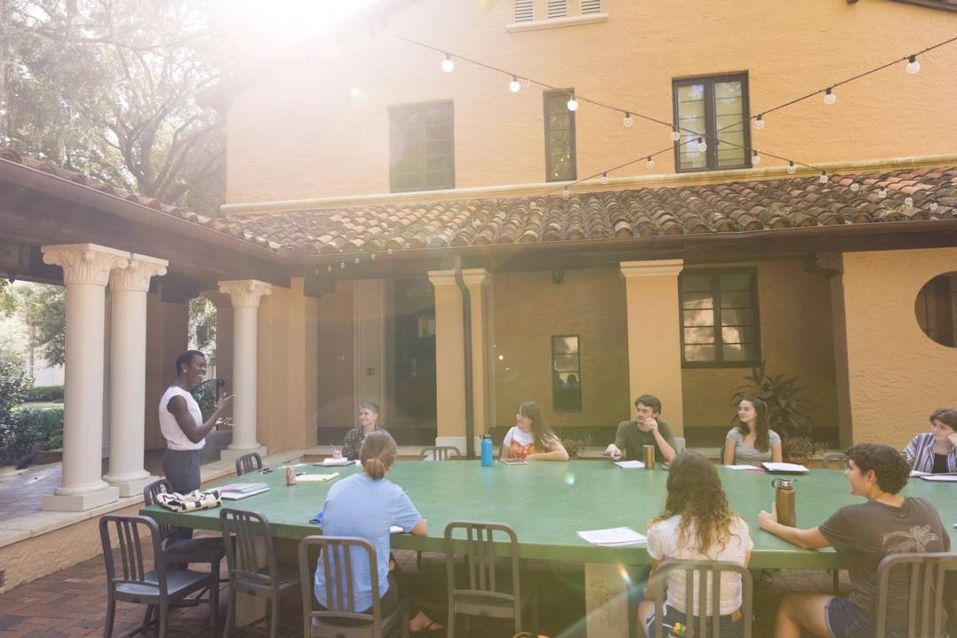 An English professor leads a class discussion in an outdoor classroom at Rollins College.