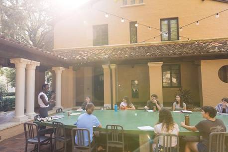 An English professor leads a class discussion in an outdoor classroom at Rollins College.