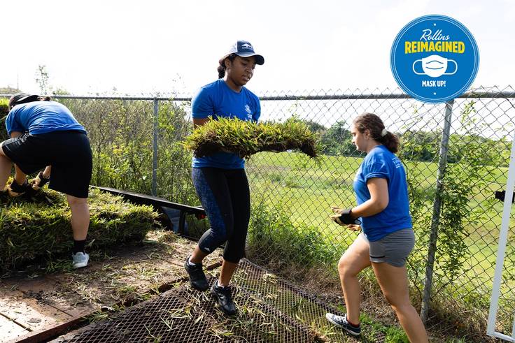 Donayja Gates ’23 planting sod at a community center for SPARC Day, Rollins’ annual day of service.