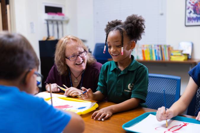 A child and teacher at Rollins’ Hume House Child Development & Student Research Center