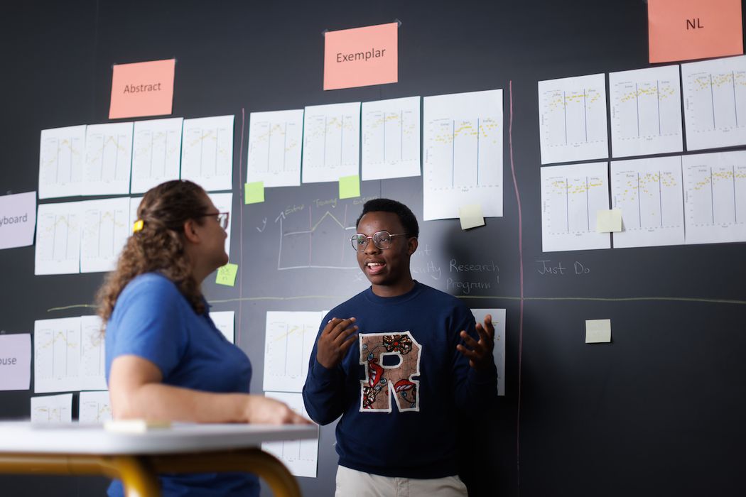 A Rollins student talks with their professor. 