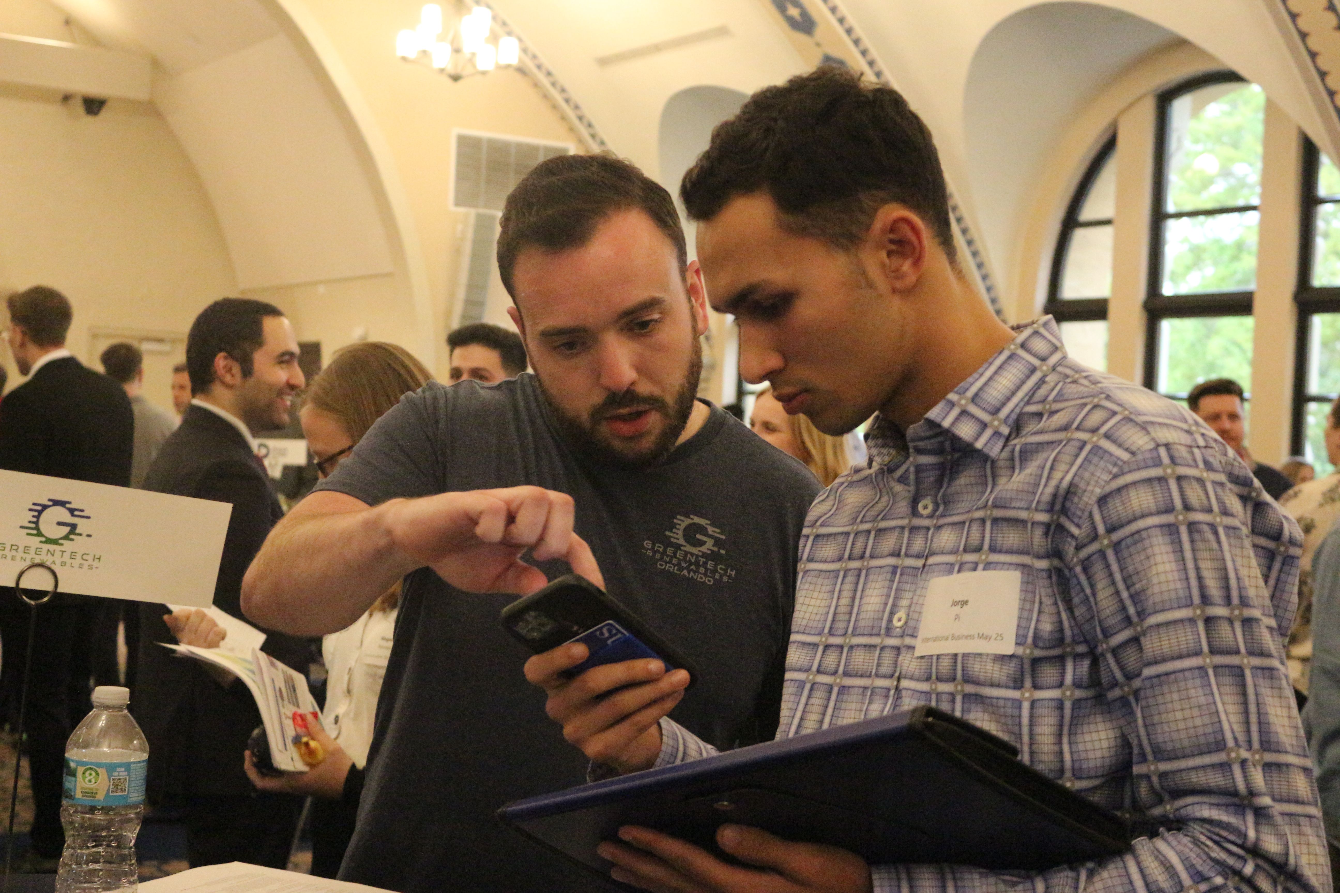 Male student speaking to employer at job fair