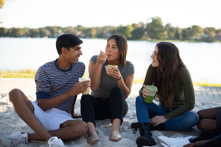 Students gather at the campus beach to enjoy snacks between class.